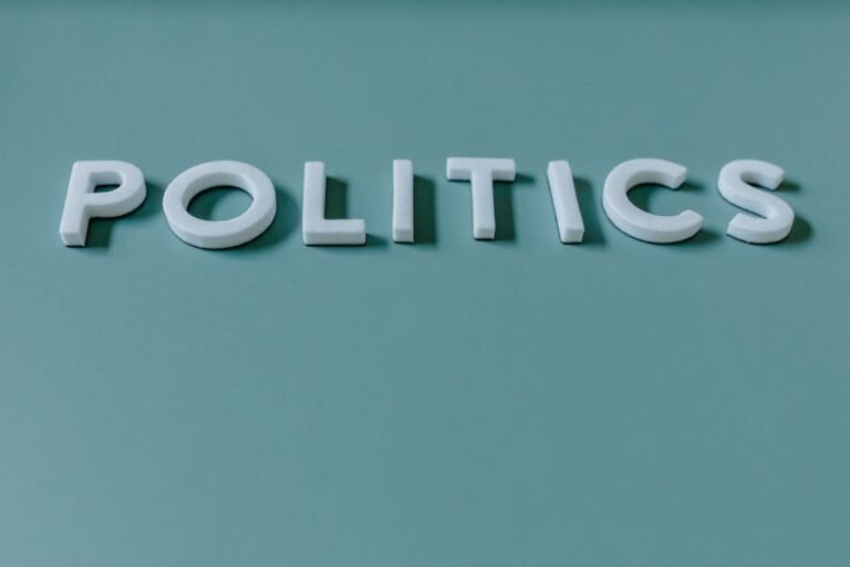Close-up image of the word 'Politics' against a teal green background, highlighting political themes.